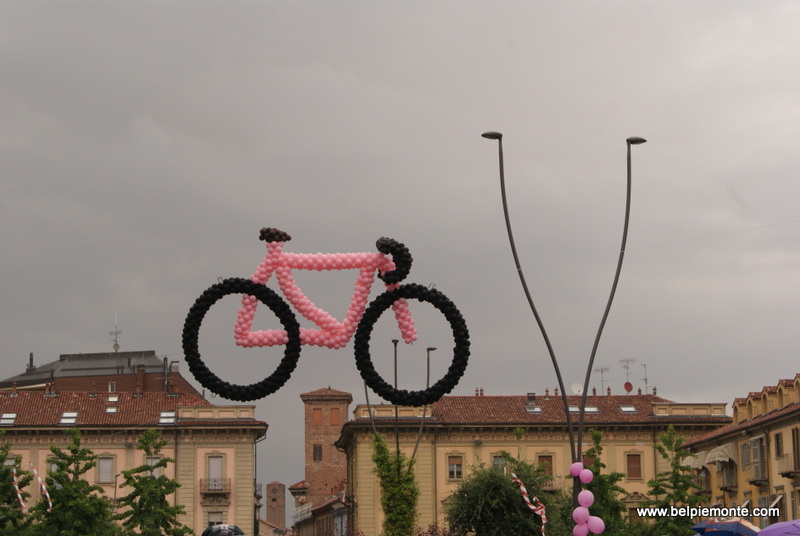 A pink bicycle suspended in the air